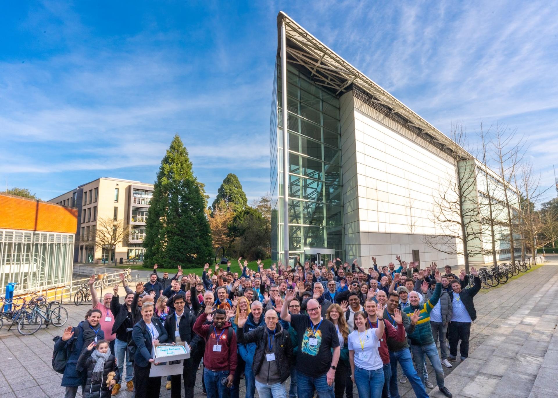 Delegates pose for a group photo in front of the Cambridge Faculty of Law, where, DrupalCamp England 2025 was held.