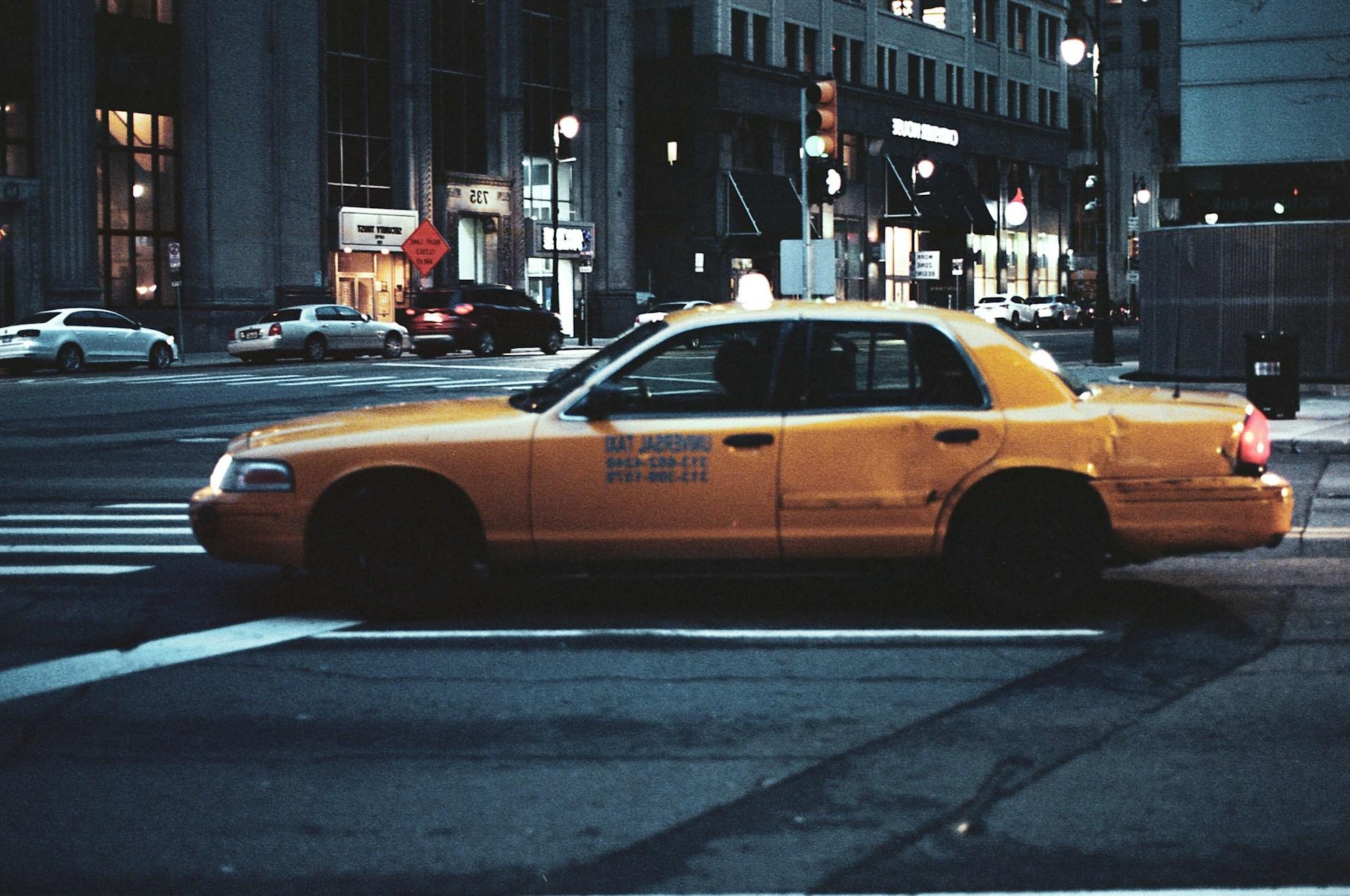 a yellow taxi in a city