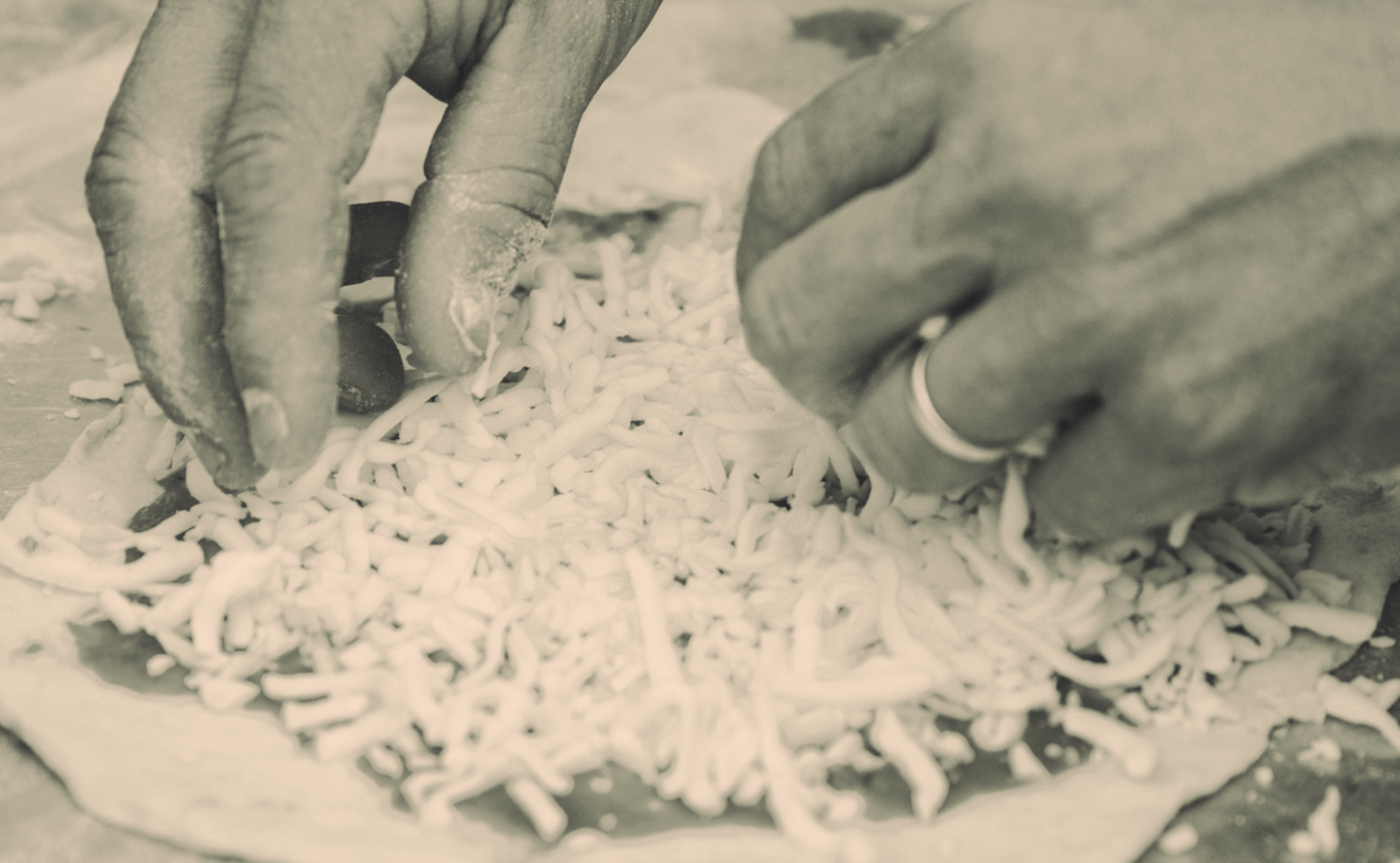 Spreading the cheese for pizza making