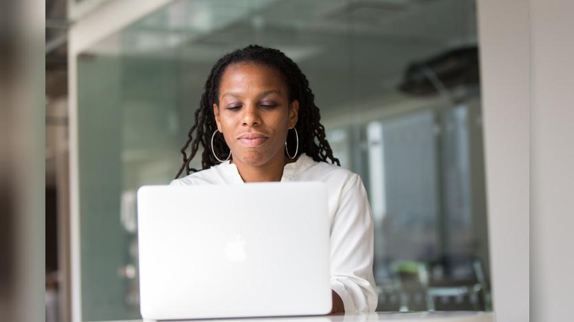 A woman working on macbook