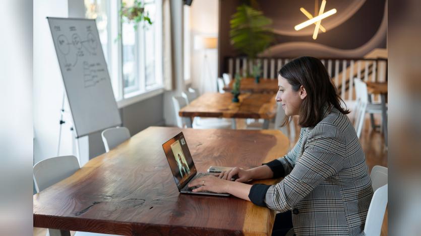 Women working on silver Macbook