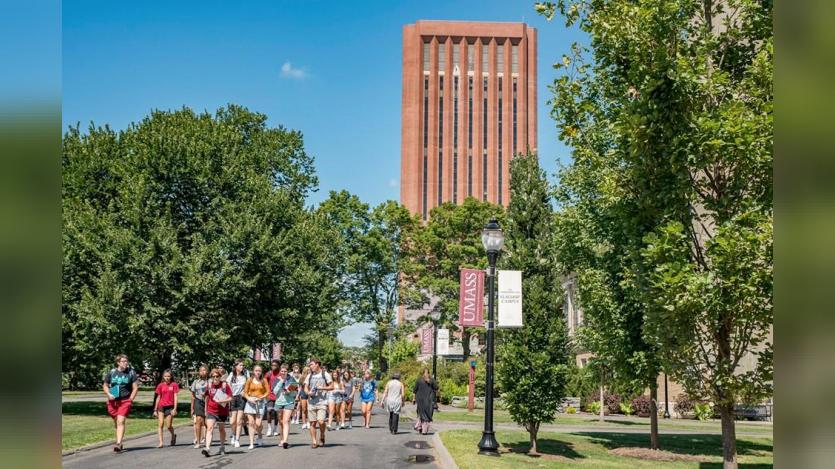 students running in front of UMass Amherst