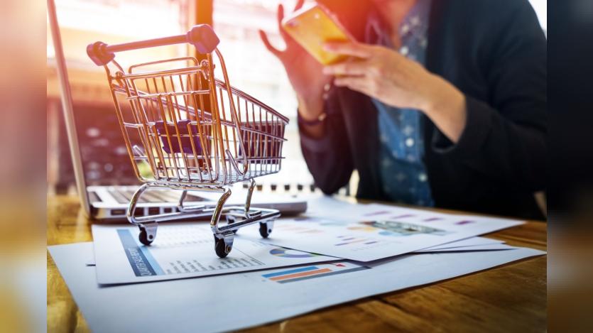 image of woman inputting card information and key on phone or laptop while shopping online.