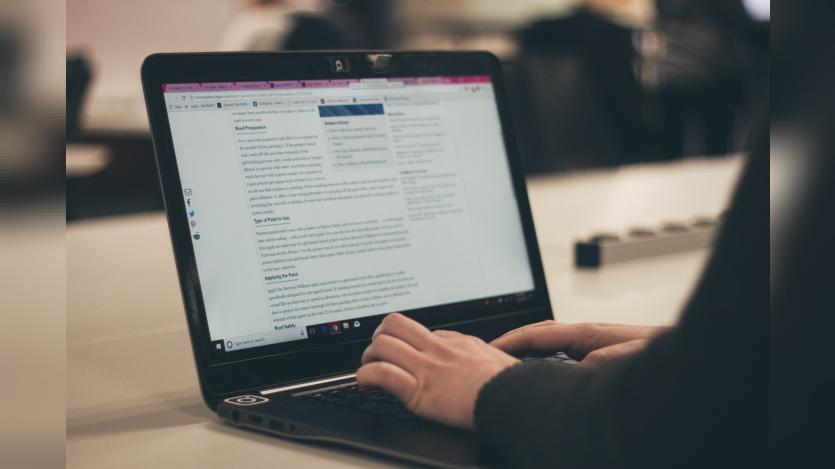 a person typing in laptop