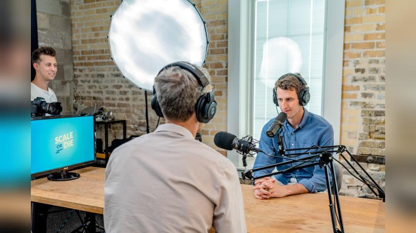 Men speaking onto microphone