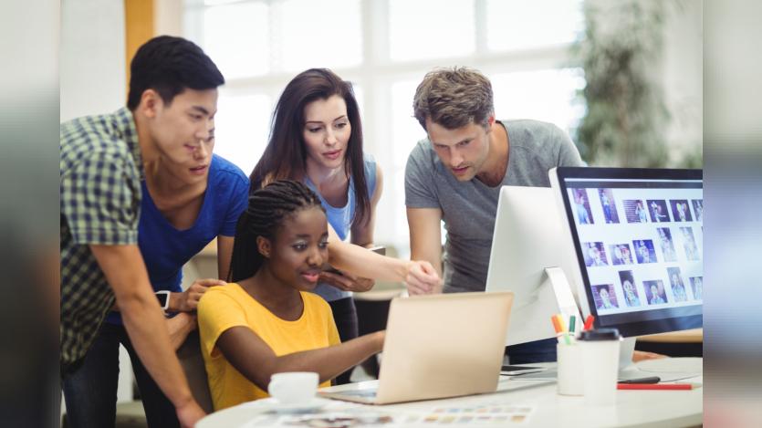 graphic designers discussing over laptop