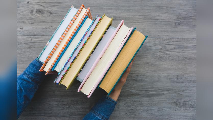 Top view of hands with books