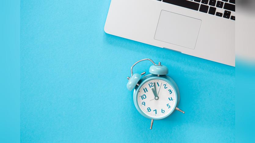 an alarm-clock-laptop-blue-background-flat-