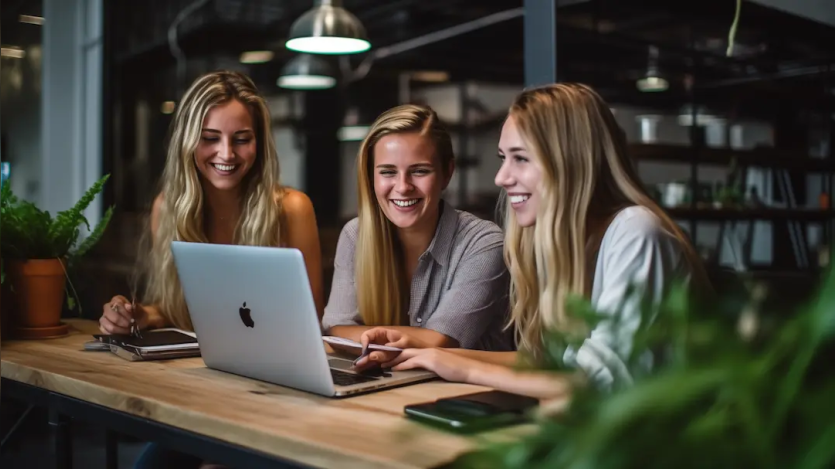 three women working on a computer