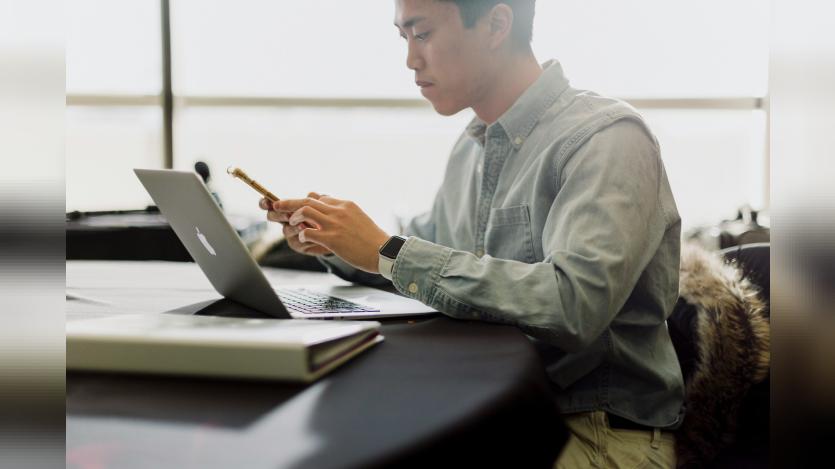 a-man-sitting-in-front-of-a-laptop-computer