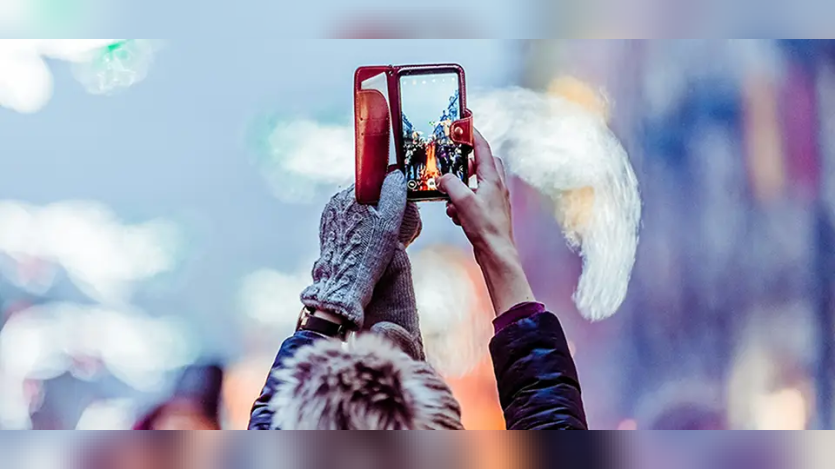 Girl clicking the picture of a bird