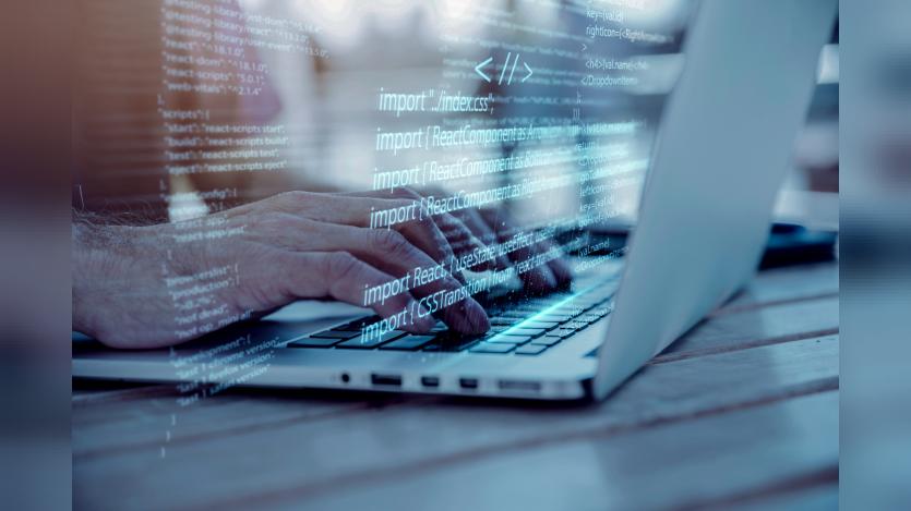 Programming background with person working with codes on computer