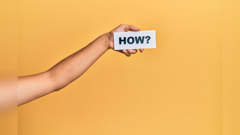 Hand of caucasian man holding paper with how word over isolated white background