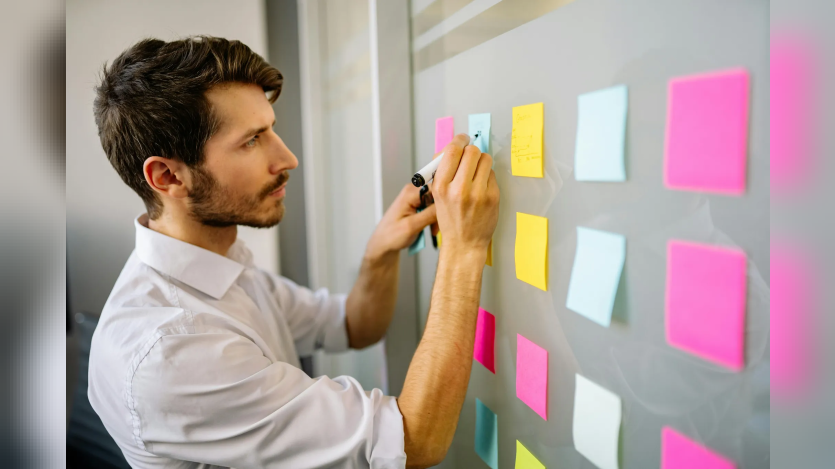 Man writing on sticky notes