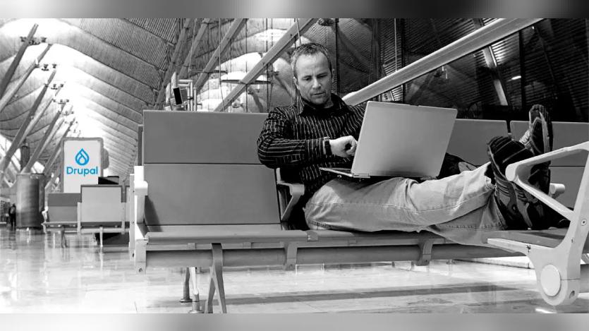 man with laptop in airport