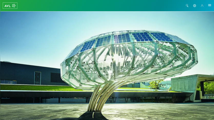A modern solar tree sculpture with solar panels, set in a landscaped area.