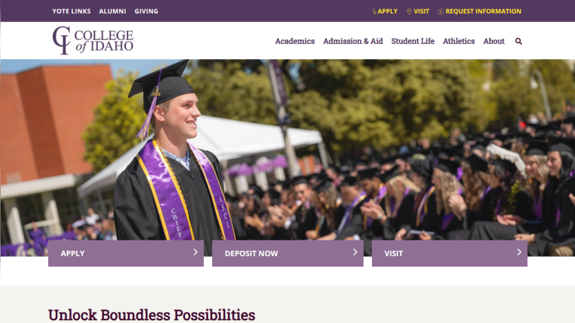 College of Idaho homepage with navigation links and a graduation ceremony hero image featuring a smiling graduate