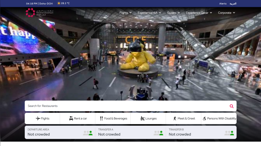Airport terminal with large yellow bear sculpture, search bar for flights, hotels, and more, and navigation menu