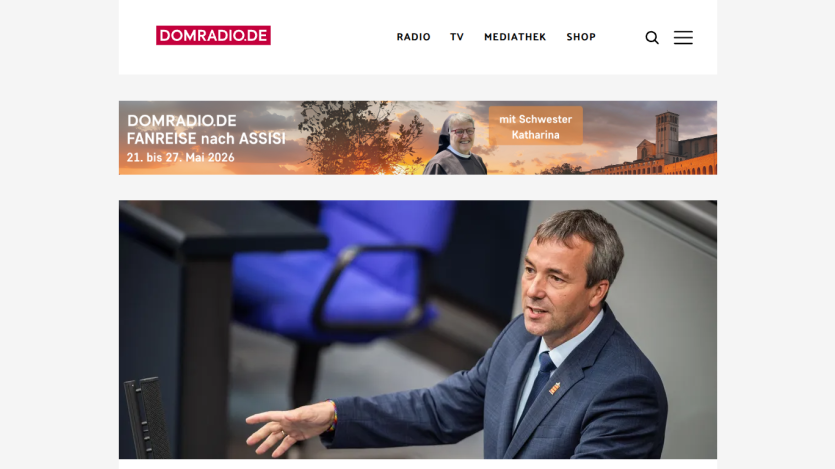 Website header with navigation links and a news article featuring a speaker at a podium.