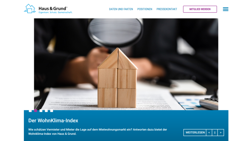 Haus & Grund website showing WohnKlima-Index with wooden house blocks and market assessment text