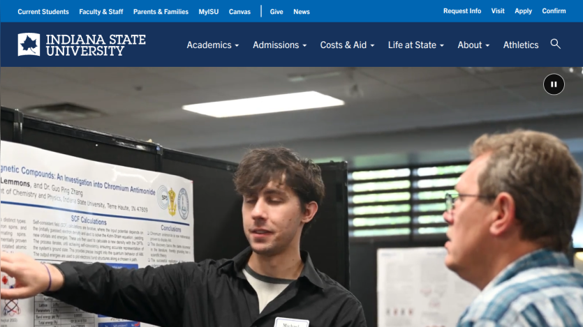 A student presenting a research poster to an audience at Indiana State University.