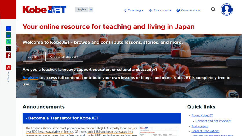 Website header with logo and menu, headline about teaching and living in Japan, and an image of traditional Japanese Daruma dolls on roof tiles