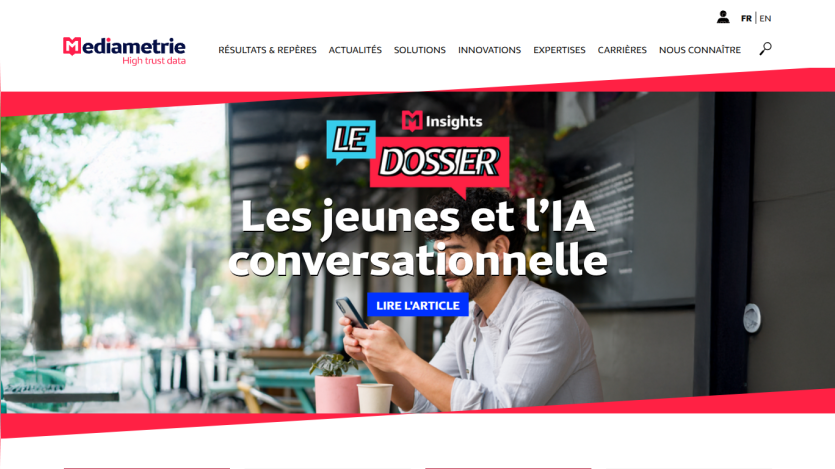 Homepage banner featuring a man working on a laptop with headline about youth and conversational AI