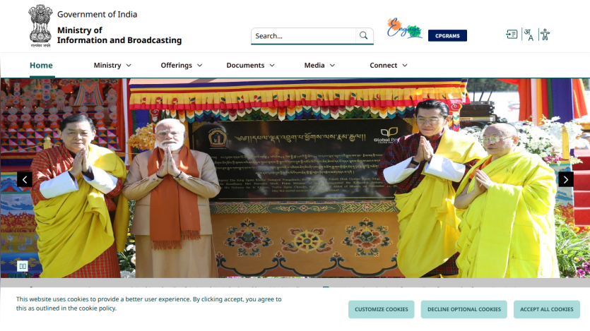 Government of India Ministry of Information and Broadcasting website with navigation menu and hero image of officials in traditional attire