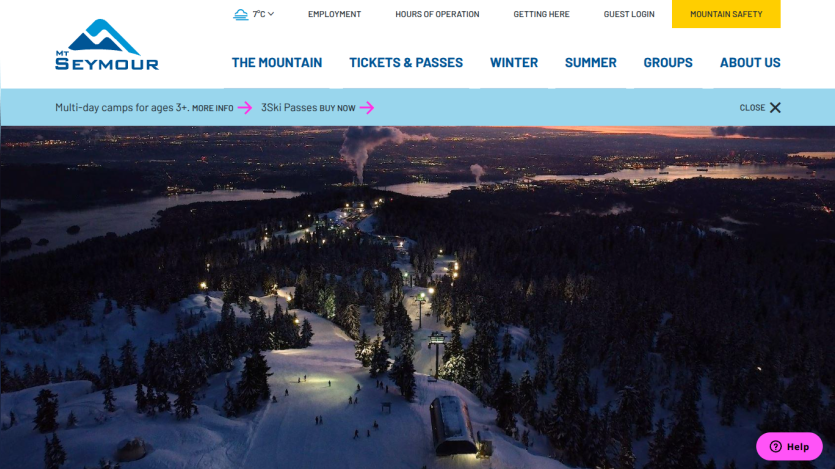 Mt Seymour ski resort website with navigation menu and night aerial view of snowy mountain slopes and ski lifts