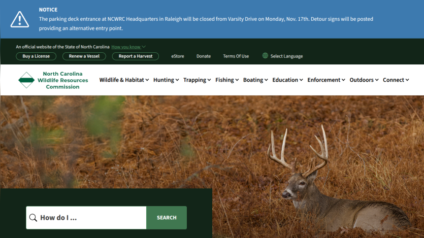 North Carolina Wildlife Resources Commission website with navigation menu and search bar over a deer in a natural habitat background