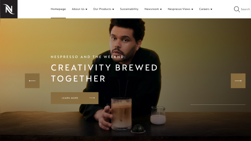 Nespresso homepage hero with headline Creativity Brewed Together and a man holding a glass of coffee