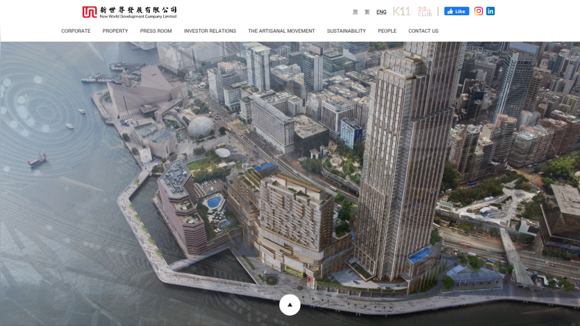 New World Development Company Limited website with navigation menu and aerial view of waterfront cityscape and buildings