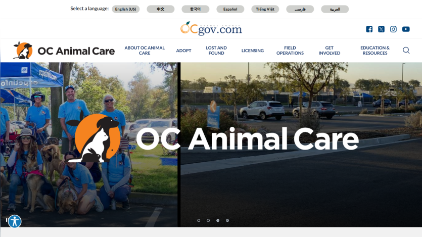 OC Animal Care website with navigation links and a group photo of staff and dogs at an outdoor event