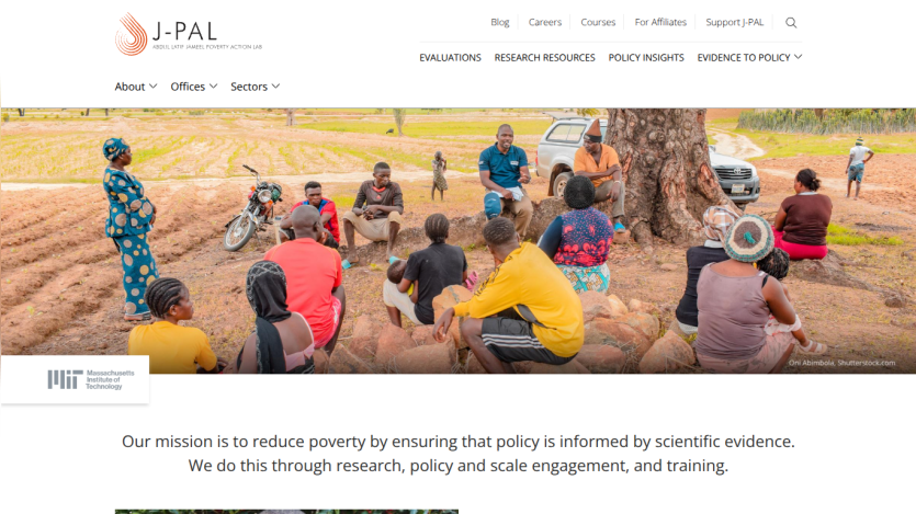 J-PAL website showcasing a group discussion in a field, emphasizing their mission to reduce poverty through evidence-based policy.