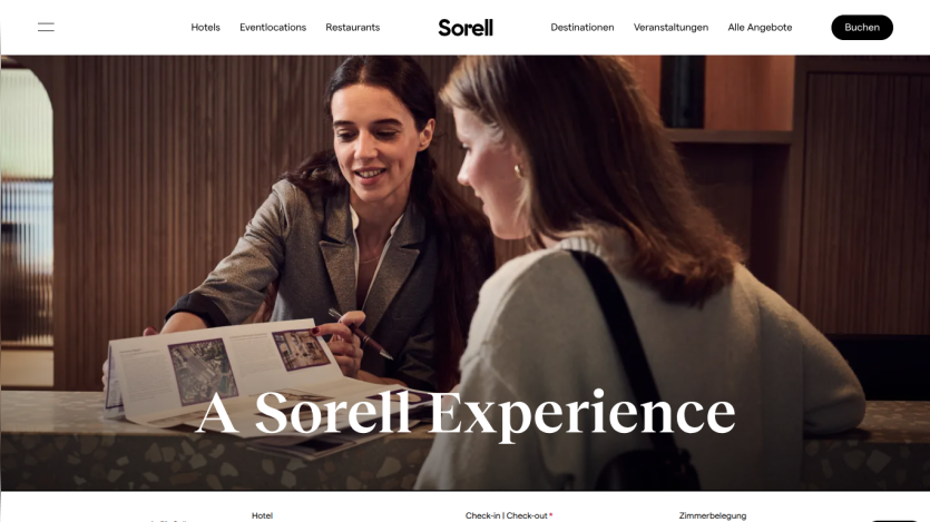 Hotel booking website header with navigation and hero image showing two women discussing a brochure with text 'A Sorell Experience'