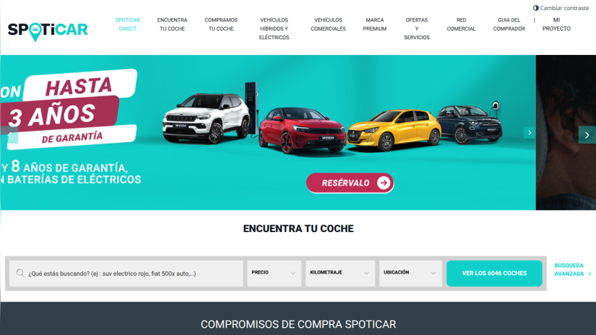 Spoticar homepage with navigation menu, hero image of two people in a car, and search bar to find used cars