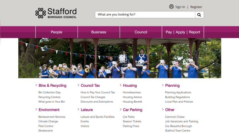 Stafford Borough Council homepage with navigation, search bar, and community service links under a band playing in a park