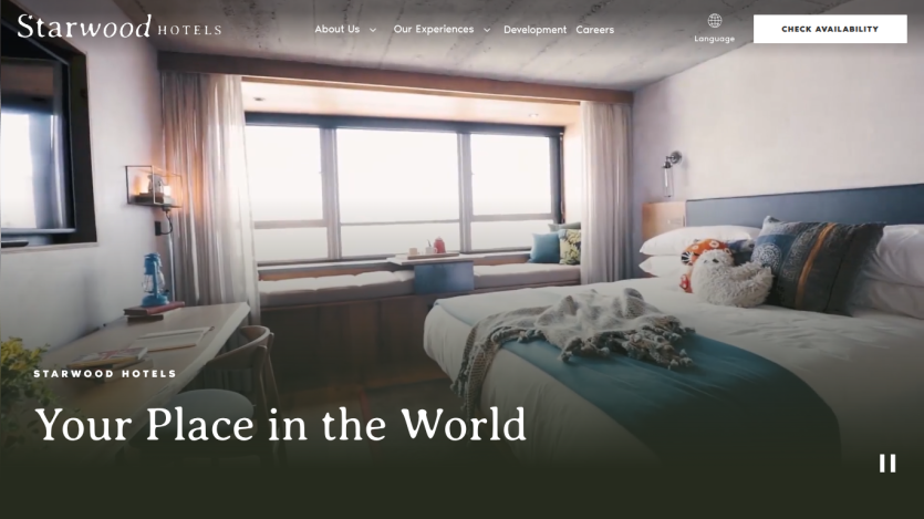 A hotel room with a bed and window, featuring the text 'Your Place in the World.'