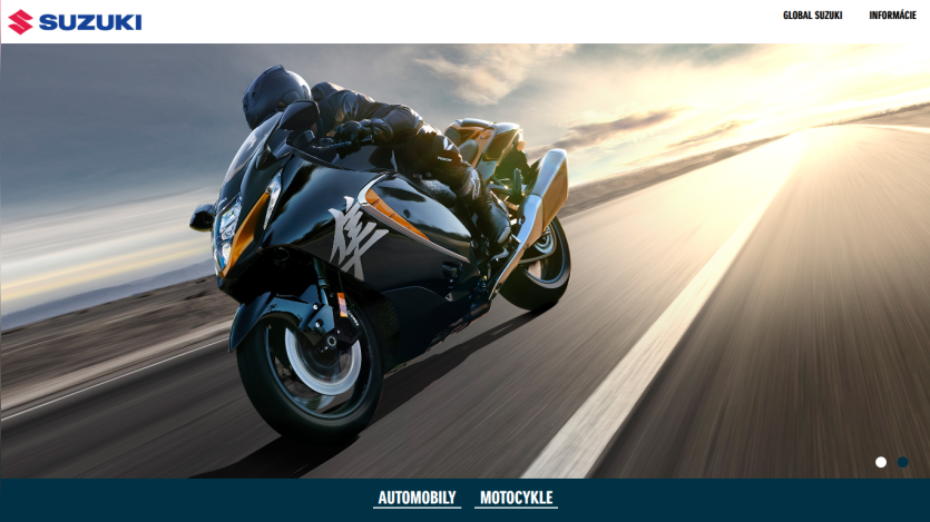 Suzuki website hero with a motorcyclist riding a black Suzuki motorcycle on a road at sunset, navigation links for Automobily and Motocykle