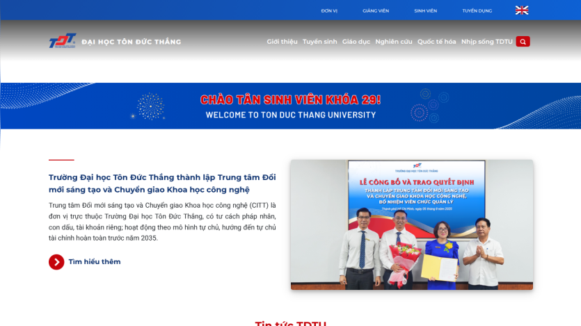 Welcome message and image of a university event at Ton Duc Thang University.