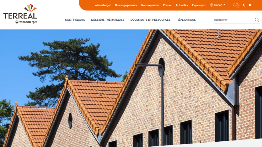Terreal website header with navigation and hero image showing houses with terracotta tiled roofs under a clear blue sky