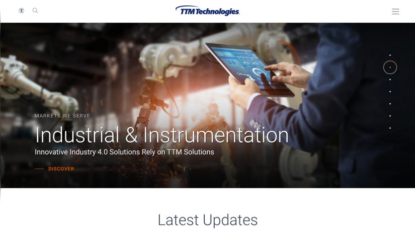 TTM Technologies homepage featuring Industrial & Instrumentation market solutions with a person using a tablet and robotic arms in the background