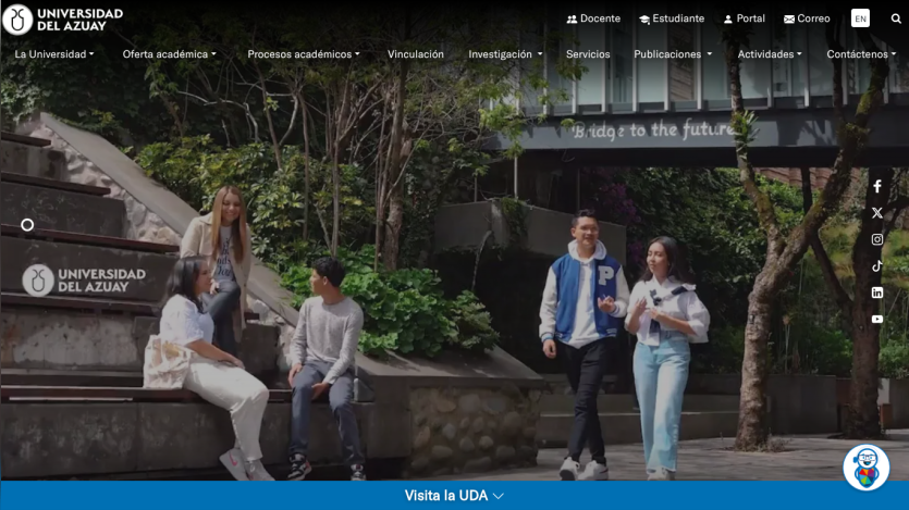Students walking on campus with greenery and university branding in view.