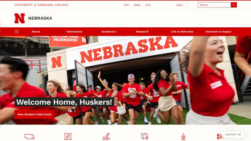 University of Nebraska homepage featuring students welcoming newcomers with a banner saying 'Welcome Home, Huskers!'