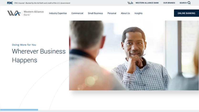 Homepage of Western Alliance Bank featuring a man in conversation with the text 'Wherever Business Happens'.