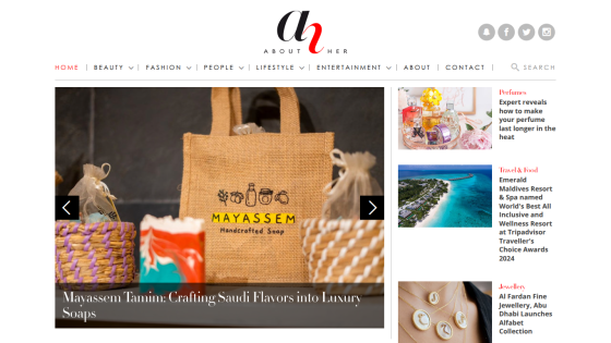 Lifestyle website homepage featuring a navigation bar and a hero image showcasing a Mayasseh branded bag with artisan crafts.