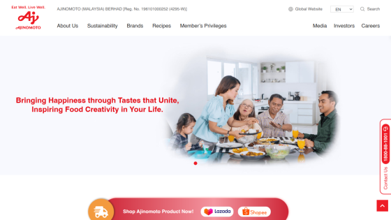 Ajinomoto Malaysia website with navigation links and a hero image of a family enjoying a meal, promoting food creativity and happiness