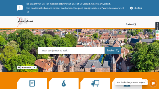 City of Amersfoort website with search bar over aerial view of city and emergency network outage alert