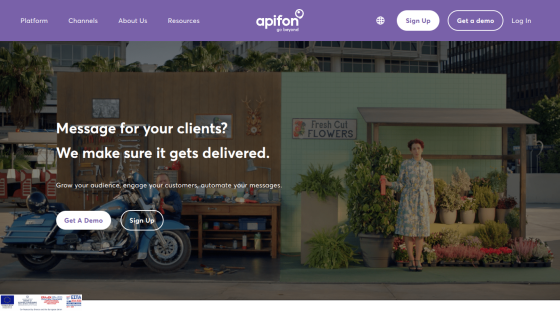 Website hero section with headline about message delivery, call-to-action buttons, and background image of a woman and motorcycle in an urban setting
