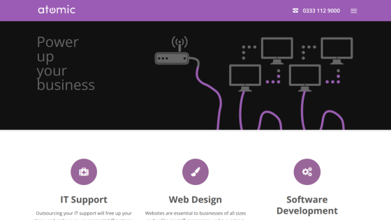 Atomic website header with contact number and hero section promoting business IT support, web design, and software development services